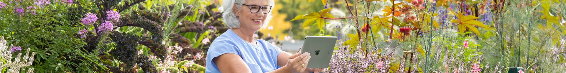 Gartenfreizeit - Frau mit Tablet im Garten Gartenfreizeit - Frau mit Tablet im Garten